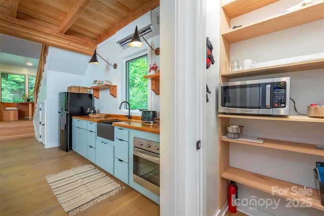 kitchen with stainless steel appliances, open shelves, a sink, wooden ceiling, and healthy amount of natural light