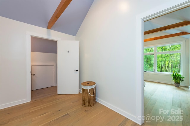 hallway with light wood-type flooring and baseboards