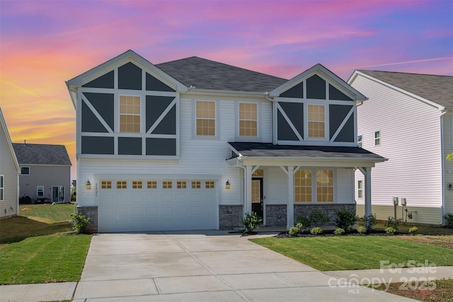 2021 Boynton St, Charlotte, NC 28269 - view of front of house with a front yard, driveway, a garage, and covered porch