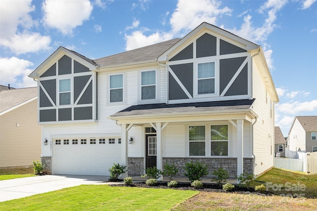 2021 Boynton St, Charlotte, NC 28269 - view of front of property featuring a garage, driveway, stone siding, a porch, and roof with shingles