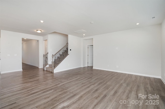 2021 Boynton St, Charlotte, NC 28269 - unfurnished living room featuring stairs, wood finished floors, baseboards, and recessed lighting