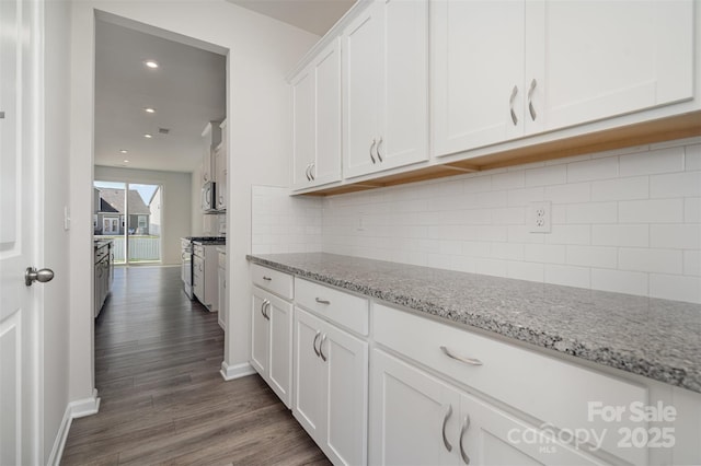 2021 Boynton St, Charlotte, NC 28269 - kitchen with white cabinetry, dark wood-style floors, light stone counters, baseboards, and recessed lighting