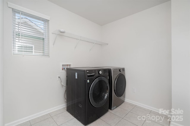 2021 Boynton St, Charlotte, NC 28269 - washroom featuring light tile patterned floors, baseboards, and washer and clothes dryer