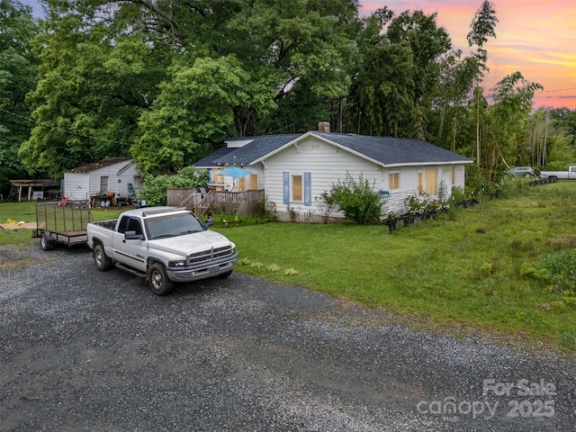 5240 Old Monroe Rd, Indian Trail, NC 28079 - ranch-style house featuring a yard, a chimney, driveway, and view of scattered trees