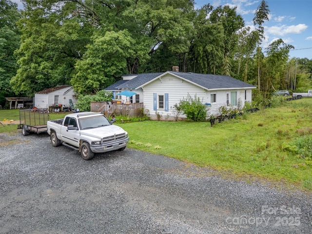5240 Old Monroe Rd, Indian Trail, NC 28079 - single story home featuring a deck, a front lawn, gravel driveway, a chimney, and a shingled roof