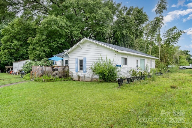 5240 Old Monroe Rd, Indian Trail, NC 28079 - view of home's exterior featuring a deck, a yard, and view of scattered trees