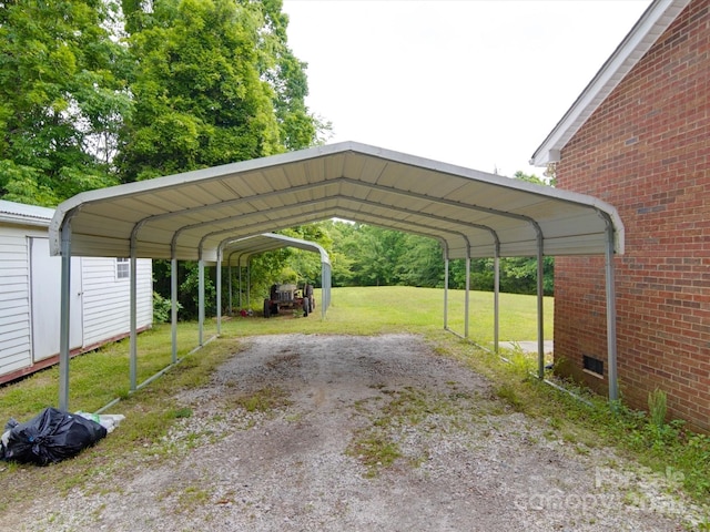 view of parking / parking lot featuring driveway and a carport