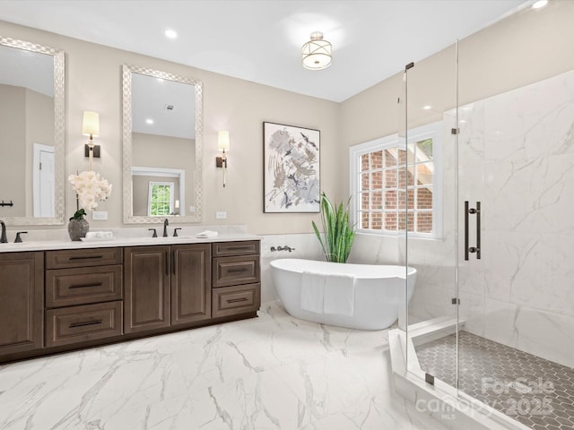 13029 Whisper Creek Dr, Charlotte, NC 28277 - full bathroom featuring double vanity, a marble finish shower, a soaking tub, marble finish flooring, and wainscoting