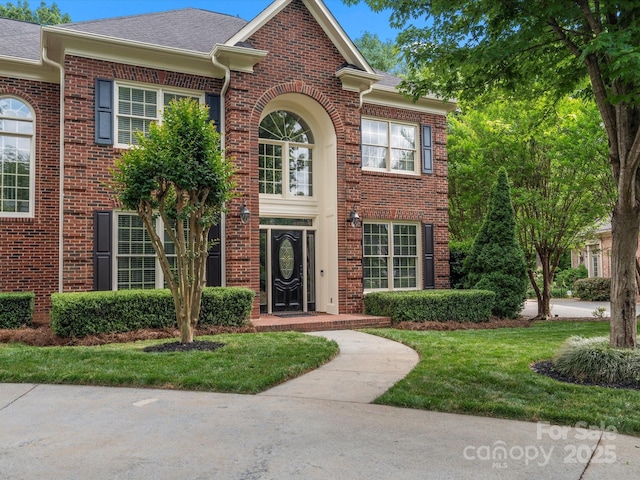 13029 Whisper Creek Dr, Charlotte, NC 28277 - view of front of home with brick siding, roof with shingles, and a front lawn