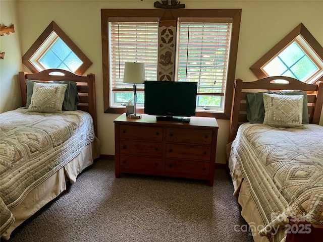 carpeted bedroom featuring baseboards