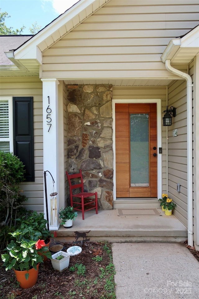 doorway to property with stone siding
