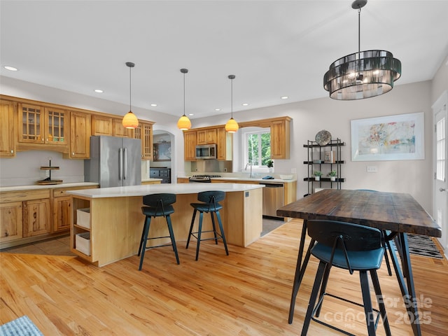 33 Village Pointe Ln, Asheville, NC 28803 - kitchen with appliances with stainless steel finishes, a kitchen island, light wood finished floors, light countertops, and recessed lighting