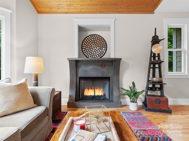 33 Village Pointe Ln, Asheville, NC 28803 - living room with wood finished floors, a warm lit fireplace, wooden ceiling, and baseboards