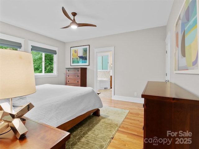 33 Village Pointe Ln, Asheville, NC 28803 - bedroom featuring light wood finished floors, connected bathroom, baseboards, and ceiling fan