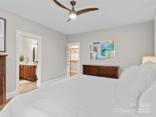 33 Village Pointe Ln, Asheville, NC 28803 - bedroom featuring baseboards, a spacious closet, ensuite bathroom, and ceiling fan