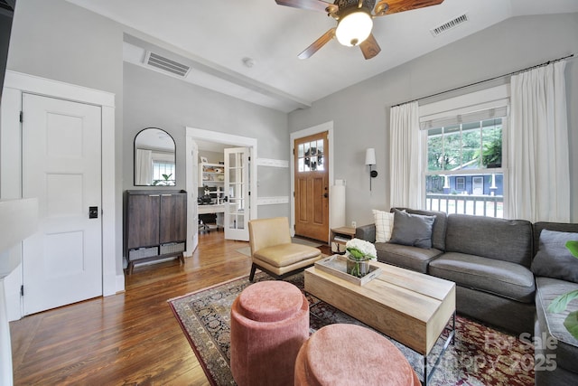 living room featuring wood finished floors, a ceiling fan, plenty of natural light, and vaulted ceiling