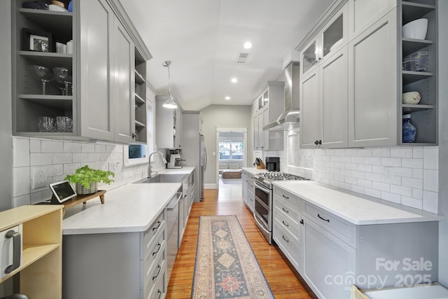 kitchen with open shelves, double oven range, a sink, light countertops, and light wood-style flooring