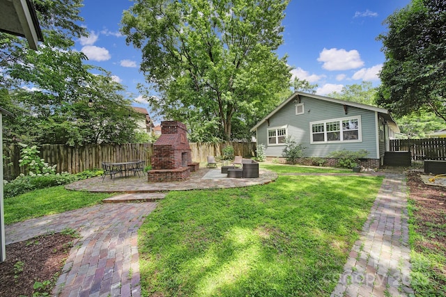 view of yard featuring an outdoor brick fireplace, a patio area, and cooling unit