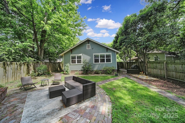 back of property with a patio and an outdoor living space