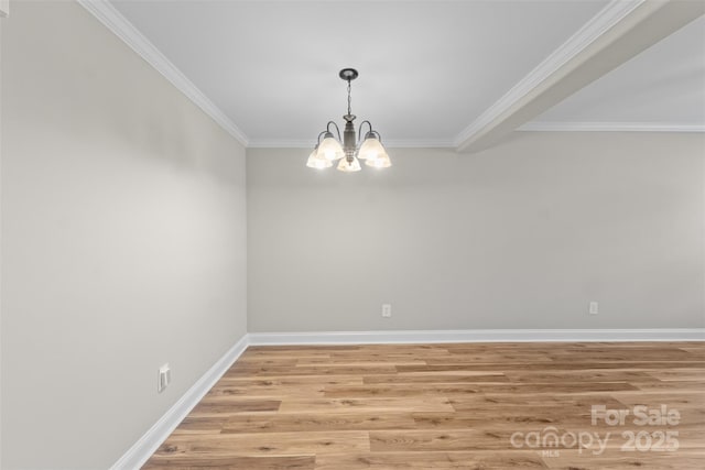 empty room featuring baseboards, ornamental molding, a chandelier, and light wood-type flooring