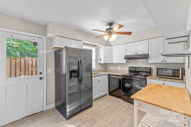 kitchen with a ceiling fan, white cabinetry, wood finish floors, black appliances, and under cabinet range hood