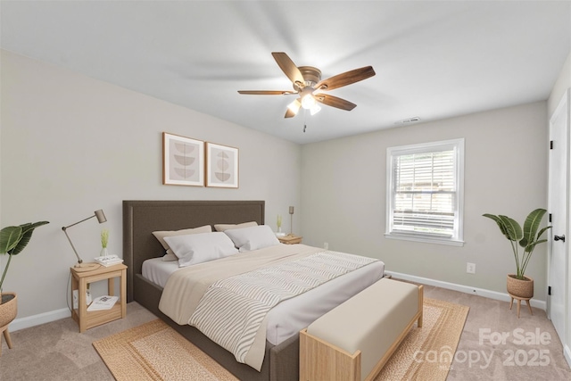 bedroom with light colored carpet, visible vents, baseboards, and a ceiling fan