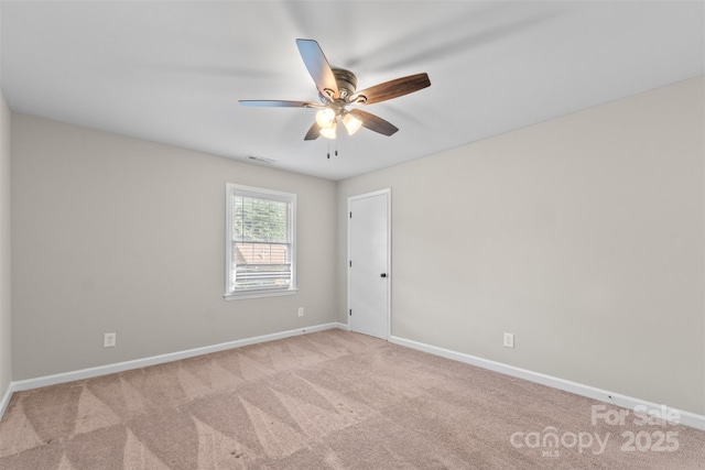 carpeted empty room featuring ceiling fan, baseboards, and visible vents