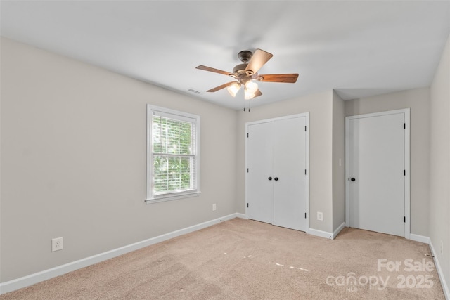 unfurnished bedroom featuring baseboards, a closet, visible vents, and carpet floors