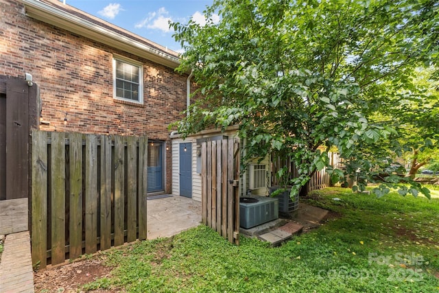 exterior space featuring central AC unit and fence