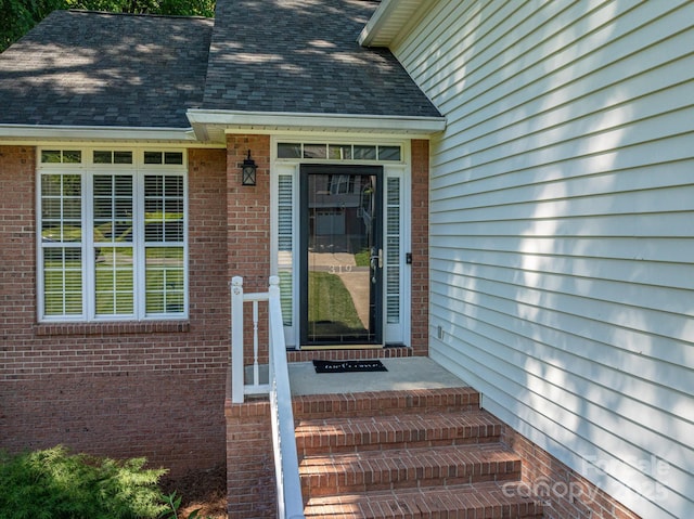319 Beacon Hills Dr, Gastonia, NC 28056 - view of exterior entry featuring a shingled roof and brick siding