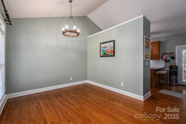 319 Beacon Hills Dr, Gastonia, NC 28056 - unfurnished dining area with a chandelier, wood finished floors, baseboards, and lofted ceiling