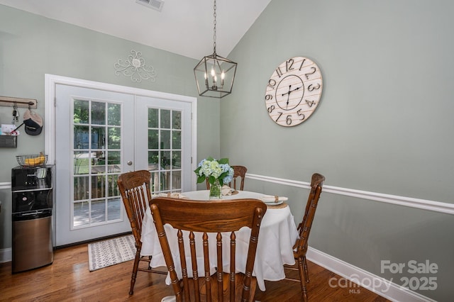319 Beacon Hills Dr, Gastonia, NC 28056 - dining space featuring french doors, lofted ceiling, a chandelier, wood finished floors, and baseboards