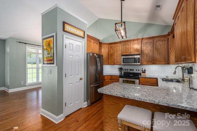 319 Beacon Hills Dr, Gastonia, NC 28056 - kitchen featuring appliances with stainless steel finishes, a sink, a peninsula, light stone counters, and dark wood finished floors
