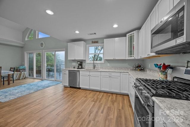 1077 Jackson Rd, Fort Lawn, SC 29714 - kitchen featuring stainless steel appliances, a sink, white cabinets, light wood-style flooring, and light stone countertops