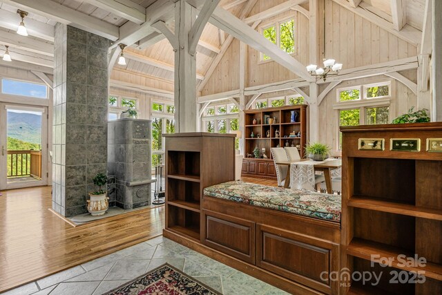 sunroom / solarium featuring a chandelier
