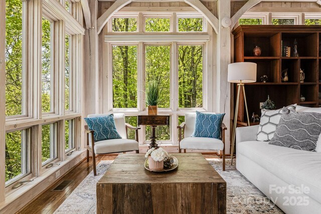 sunroom / solarium with healthy amount of natural light and wood finished floors