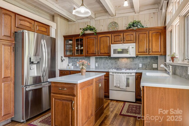 kitchen with white appliances, wood ceiling, dark wood-style floors, beamed ceiling, and light countertops