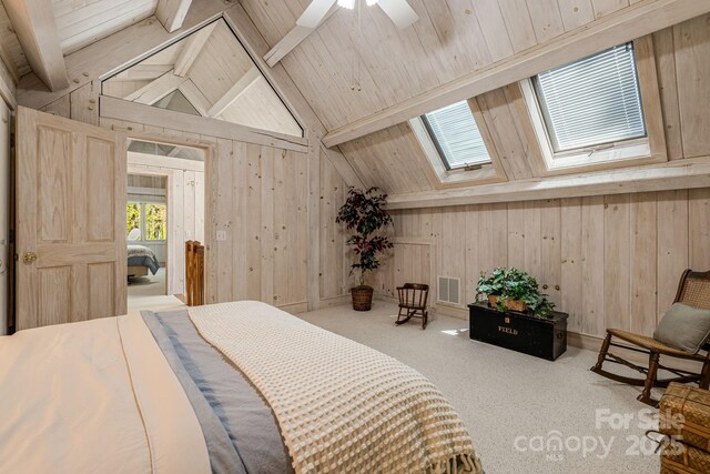 carpeted bedroom with wood walls, a skylight, and wood ceiling
