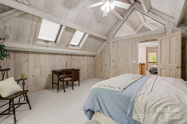 carpeted bedroom with a skylight, wood walls, and wooden ceiling