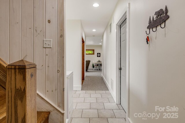 hall with recessed lighting, light tile patterned floors, light carpet, and baseboards