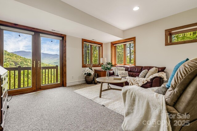 living area with a mountain view, carpet flooring, recessed lighting, and baseboards