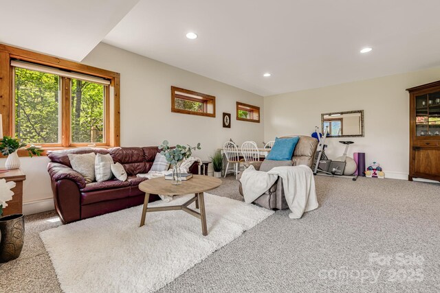carpeted living area featuring recessed lighting and baseboards