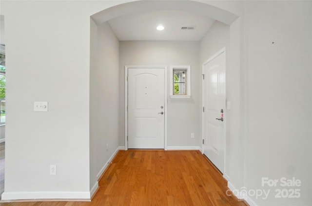 5028 Polo Gate Blvd, Charlotte, NC 28216 - foyer entrance with arched walkways, light wood-style floors, and baseboards