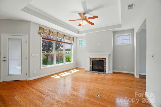 5028 Polo Gate Blvd, Charlotte, NC 28216 - unfurnished living room with a tray ceiling, healthy amount of natural light, wood finished floors, ceiling fan, and ornamental molding