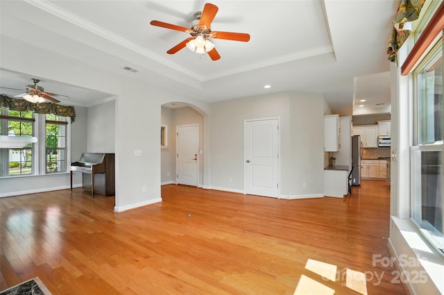 5028 Polo Gate Blvd, Charlotte, NC 28216 - unfurnished living room with ceiling fan, arched walkways, light wood finished floors, a raised ceiling, and baseboards