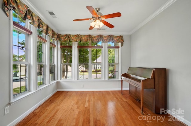 5028 Polo Gate Blvd, Charlotte, NC 28216 - unfurnished room featuring baseboards, healthy amount of natural light, ornamental molding, light wood-style floors, and ceiling fan