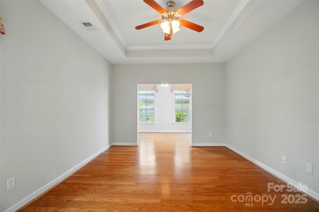 5028 Polo Gate Blvd, Charlotte, NC 28216 - unfurnished room featuring a raised ceiling, light wood-style floors, crown molding, a ceiling fan, and baseboards