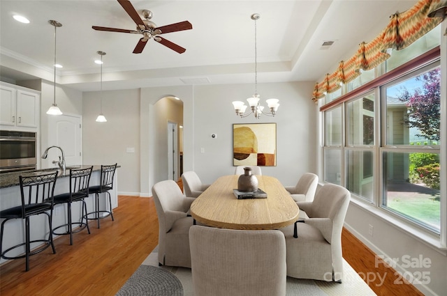 5028 Polo Gate Blvd, Charlotte, NC 28216 - dining room featuring arched walkways, a ceiling fan, a tray ceiling, plenty of natural light, and recessed lighting