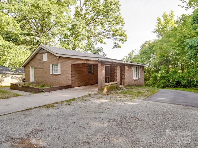 363 Sowers Rd, Linwood, NC 27299 - ranch-style house featuring brick siding, a carport, and driveway