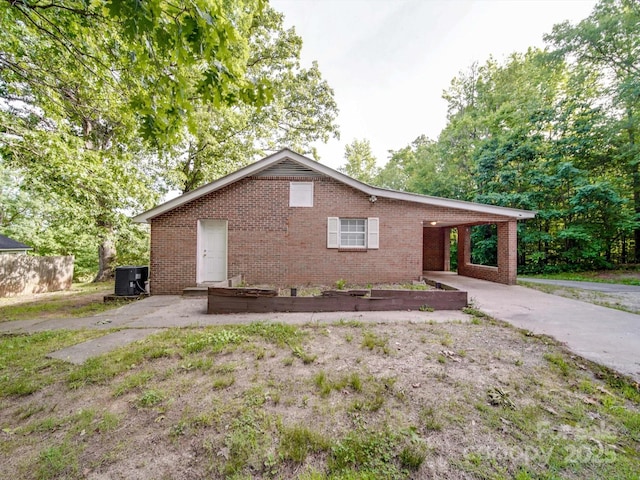 363 Sowers Rd, Linwood, NC 27299 - ranch-style home with brick siding, central AC unit, an attached carport, and driveway